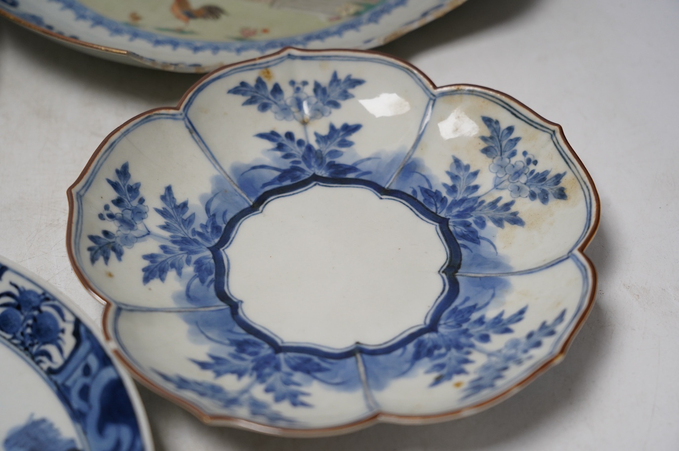 Three Japanese Kakiemon style blue and white dishes and an 18th century Chinese famille rose dish. Condition - varies